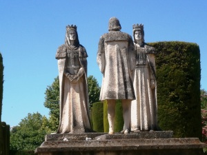 Statues of Christopher Columbus standing before Queen Isabella and King Ferdinand in the gardens of the Alcazar of Cordoba, one of many monuments honoring the memory of Columbus.